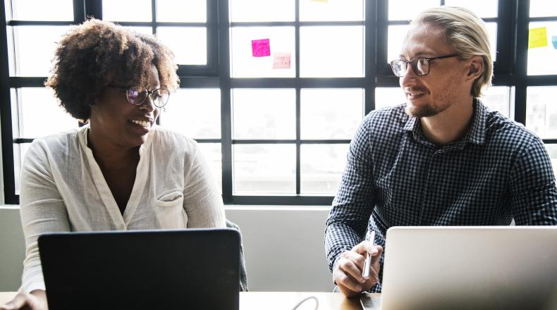 Image of a female and male work colleagues collaborating on a project