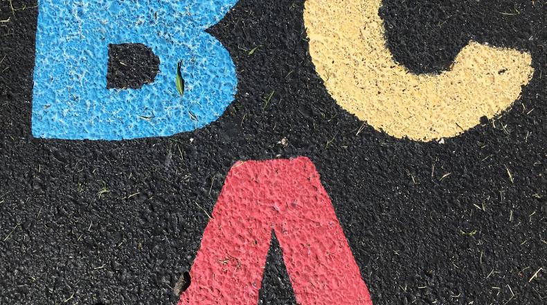 A B C written in colored chalk on ashpalt