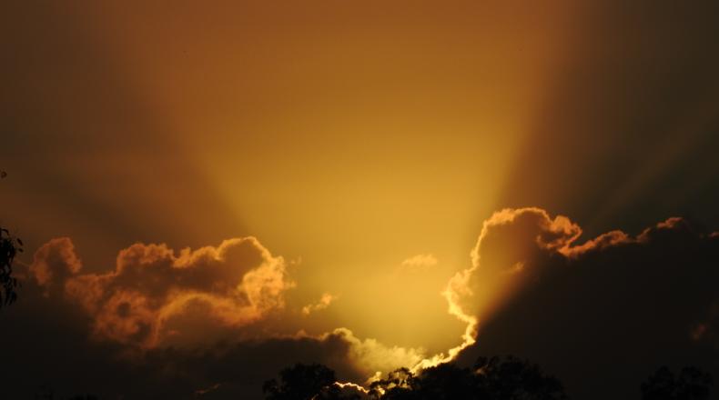 light breaking through dark clouds