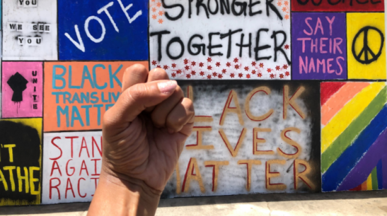 fist raised in front of signs