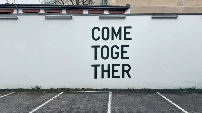 a mural reading "come together"