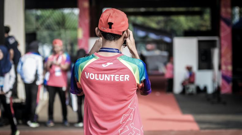 back of person wearing volunteer shirt