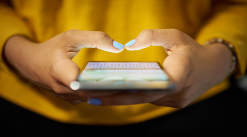 Woman holding phone prepared to text