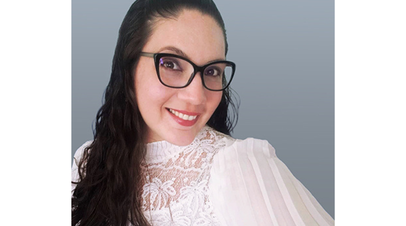 Headshot of a woman with glasses smiling