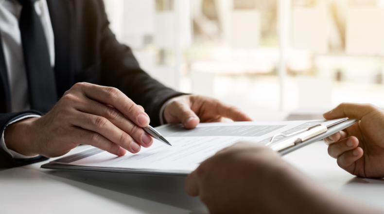 Man reviewing papers on a clipboard