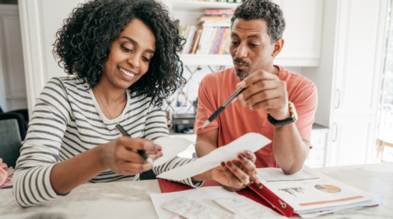 Two people looking at receipts