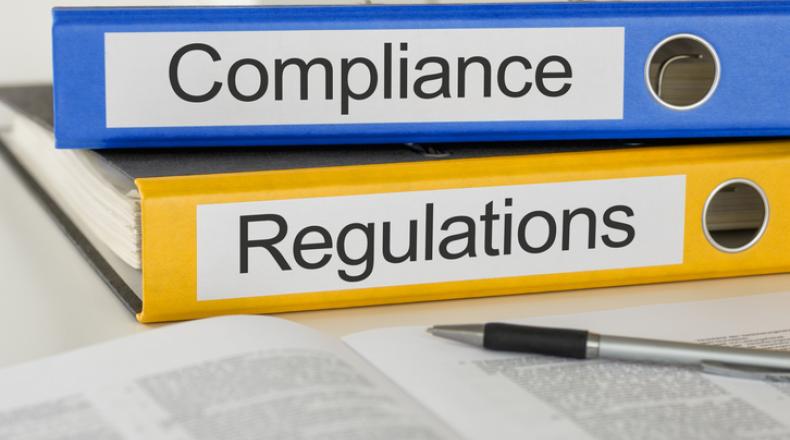 Folders with the label Compliance and Regulations stock photo