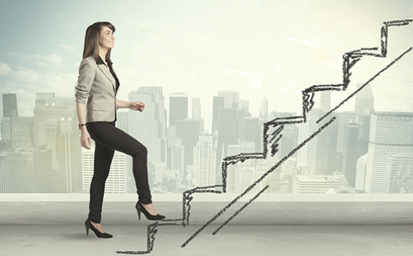 Woman walking up a set of stairs with a city skyline in the background