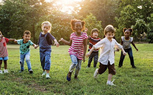 Kids running and playing in the grass