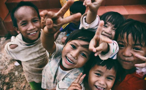 children smiling at person taking their picture