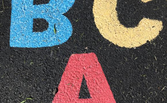 A B C written in colored chalk on ashpalt