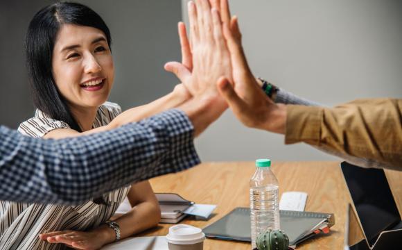 group of folks high fiving each other