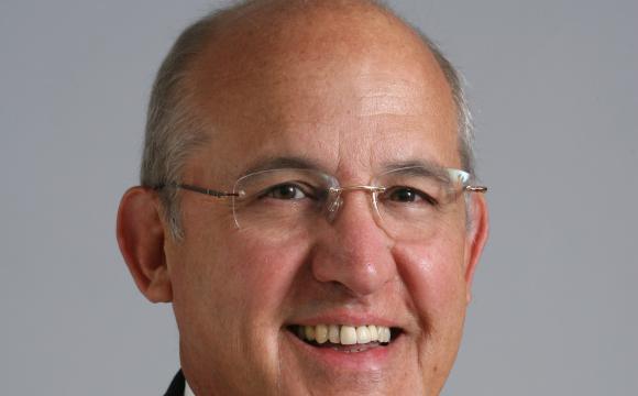 Smiling headshot of a man wearing glasses