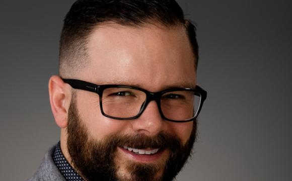 bearded man with glasses smiling 