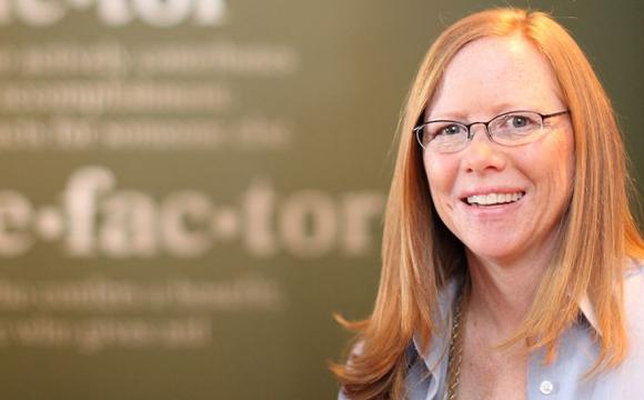 woman with glasses smiling 