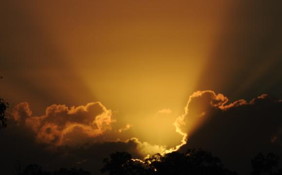 light breaking through dark clouds