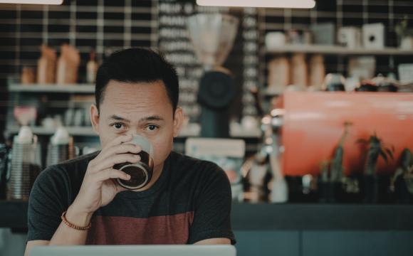 man staring up from computer