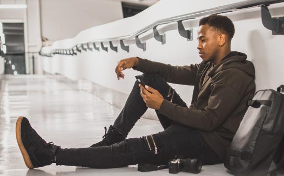 man sitting on floor at airport