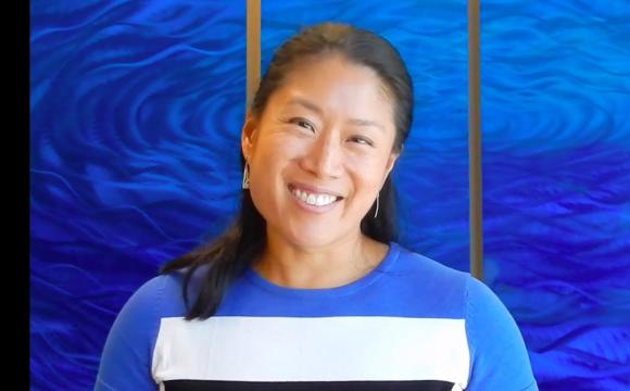 woman in a blue top smiling at the camera