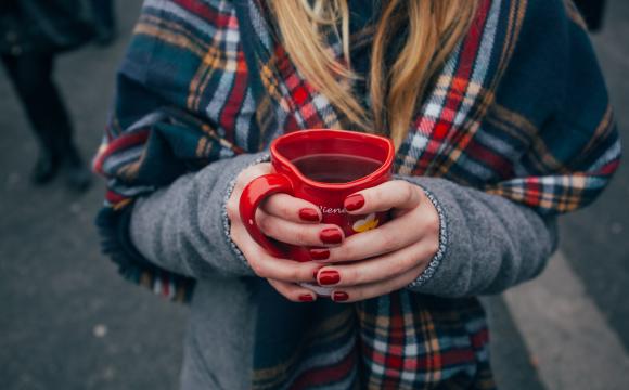 woman holding a heart-shaped mug