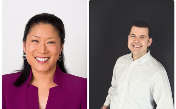 Woman in a purple top and man in white shirt and grey slacks smiling