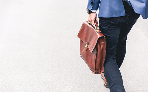 man walking and carrying a briefcase