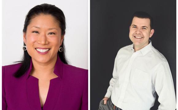 Woman in a purple top and man in white shirt and grey slacks smiling