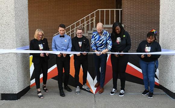 Group of people cutting a ribbon