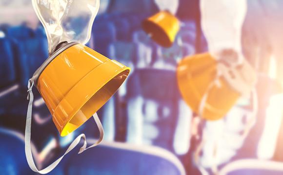 oxygen masks dropping from the ceiling on an airplane