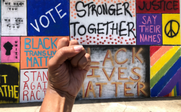 fist raised in front of signs