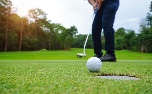 blurred golfer playing golf on a sunny day