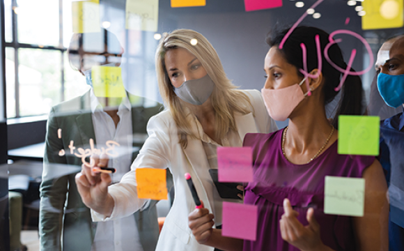 diverse women in the workplace wearing masks