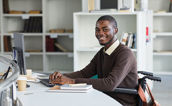 portrait of an african american disabled person at a desk