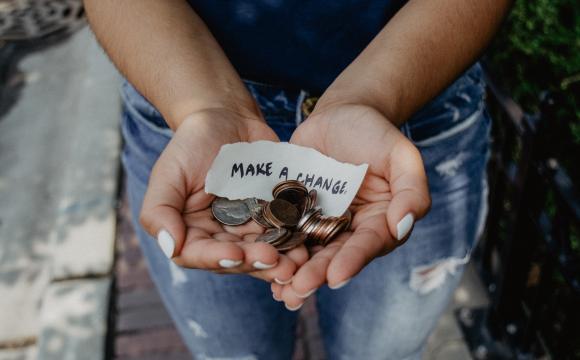 a person holding change in their outstretched hands