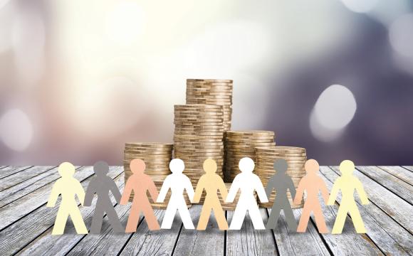 paper cut out people holding hands in front of a stack of coins