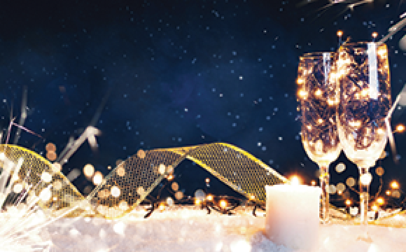 champagne glasses with gold ribbon on a blue background