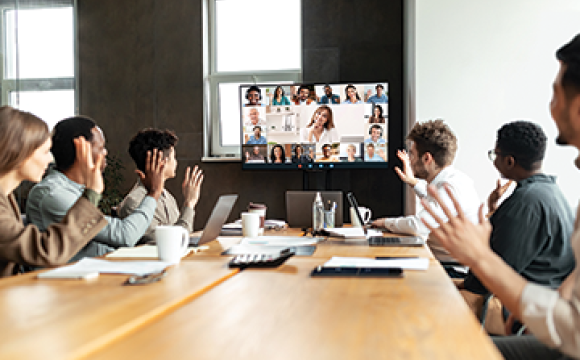 virtual meeting with people in a board room looking at a monitor