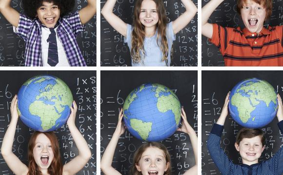 kids smiling and holding globes