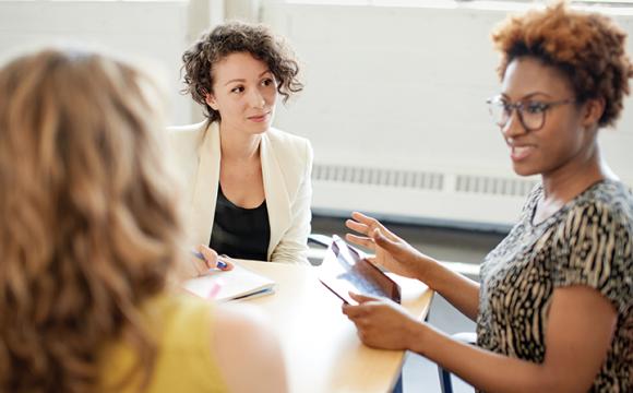 women at a table talking