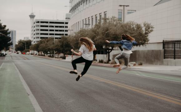 two people jumping happily