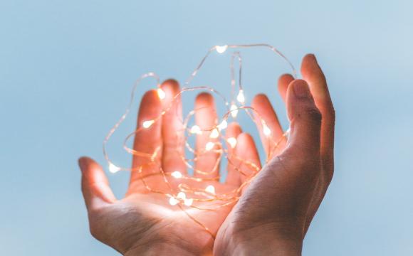 hands holding strand of white lights