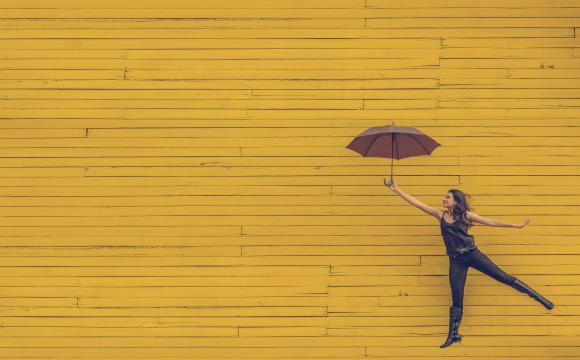 woman holding brown umbrella