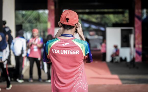 back of person wearing volunteer shirt