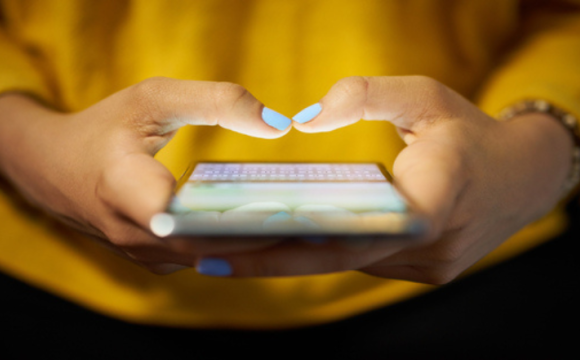 Woman holding phone prepared to text