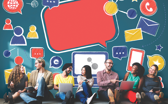 group of diverse people sitting in front of a wall with word bubbles and envelopes