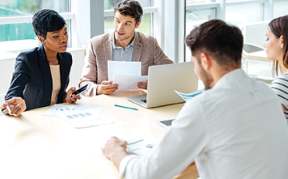 business people sitting at a table talking