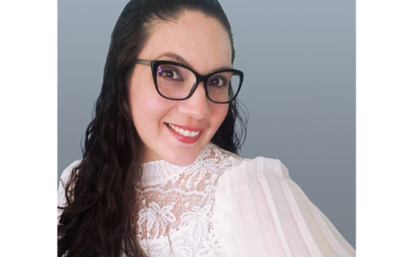 Headshot of a woman with glasses smiling