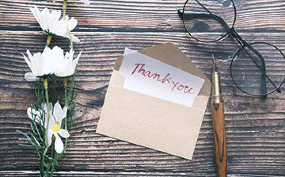 thank you letter on a wood table