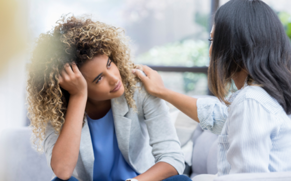 A woman comforts another woman