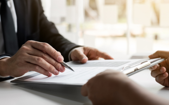 Man reviewing papers on a clipboard